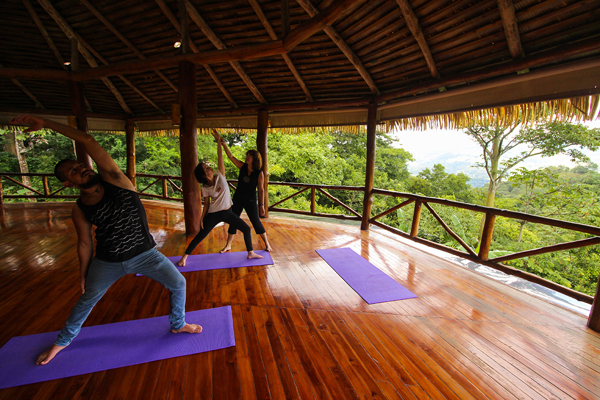 people practicing yoga at a yoga retreat in costa rica