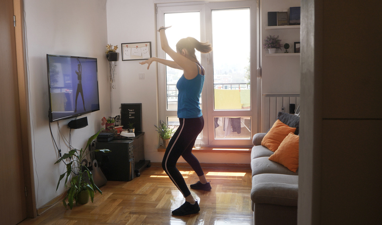 woman doing a dance workout at home